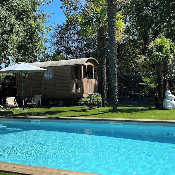 Seasonal outdoor pool, open 8:00 AM to 8:00 PM, pool umbrellas