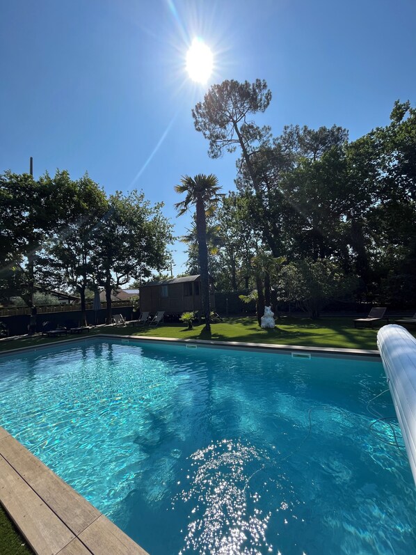 Seasonal outdoor pool, open 8:00 AM to 8:00 PM, pool umbrellas