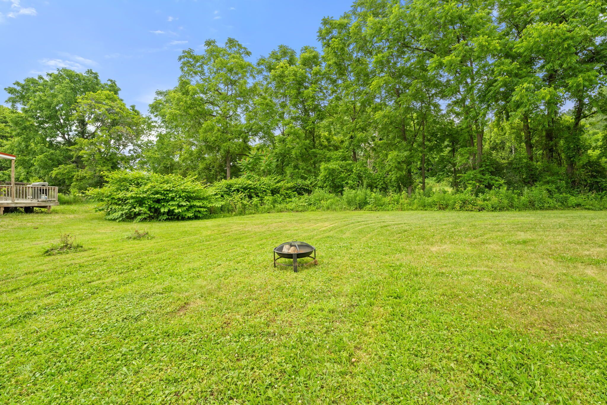 And when the sun starts to dip? The fire pit is waiting to turn this big green haven into your own cozy evening hangout. 