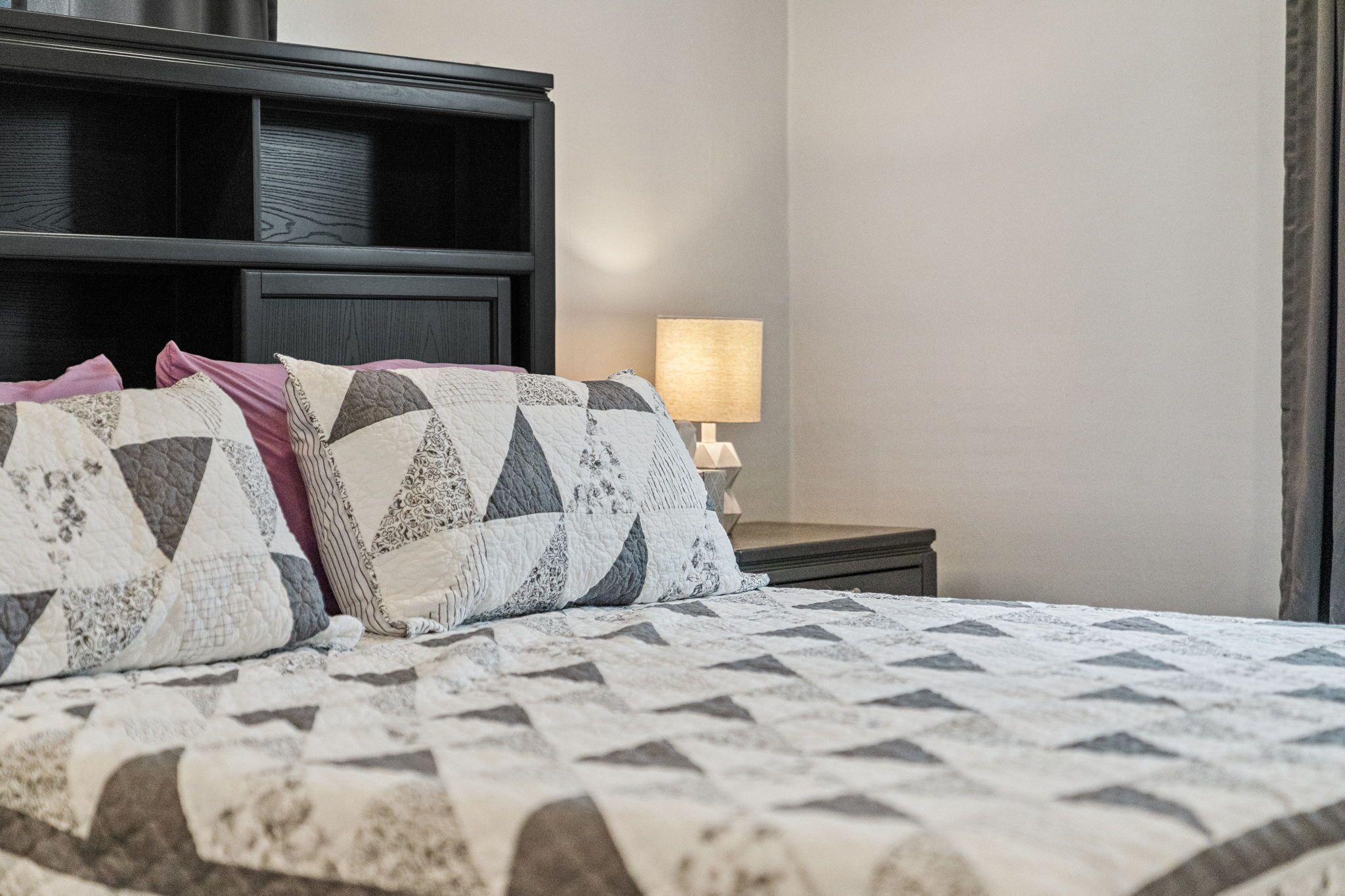 Soft linens and a warm bedside glow create the ideal spot to relax and recharge. 