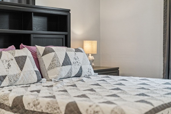 Soft linens and a warm bedside glow create the ideal spot to relax and recharge.
