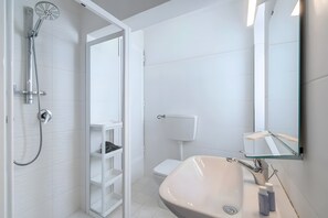 Shower, hair dryer, towels, toilet paper