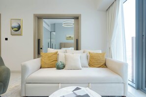 Deluxe Apartment, 1 Bedroom, Balcony | Living area | 65-inch Smart TV with cable channels, Netflix, streaming services