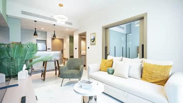 Deluxe Apartment, 1 Bedroom, Balcony | Living area | 65-inch Smart TV with cable channels, Netflix, streaming services
