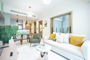 Deluxe Apartment, 1 Bedroom, Balcony | Living area | 65-inch Smart TV with cable channels, Netflix, streaming services