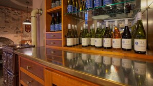 A wine cellar with shelves of wine bottles, wooden cabinets, and a glass counter. - Apartment 'Klein' with Shared Garden and Wi-Fi (Offenburg)