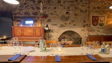 Un restaurante con paredes de piedra, muebles de madera y una chimenea.