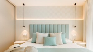 A modern hotel room with a large bed, two bedside tables, and a headboard with integrated lighting. - Apartment 2 bedroom | ground floor| mountain view (La Caleta)