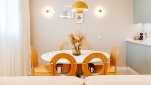 A modern dining area with a round table, wooden chairs, and pendant lighting. - Apartment 3 bedroom | ground floor| mountain view (La Caleta)