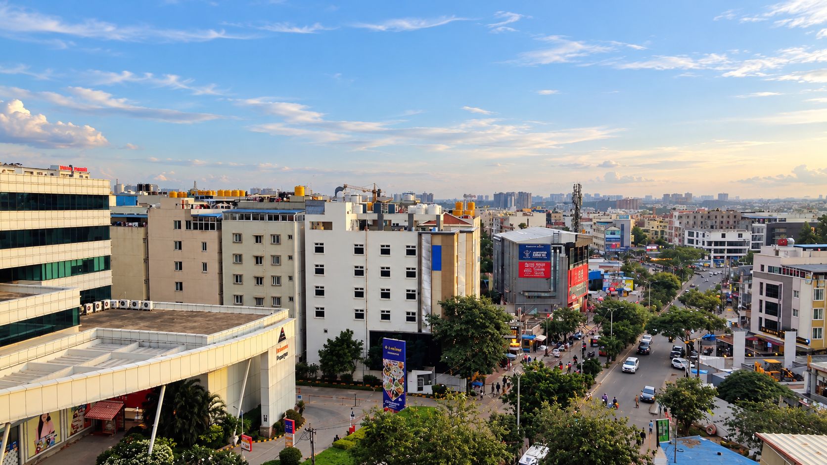 A cityscape with modern buildings, a busy street, and a clear sky.