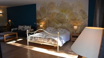 Un dormitorio con una cama, una mesita de noche, una lámpara, una mesa de centro de madera y una pared con un mural floral.