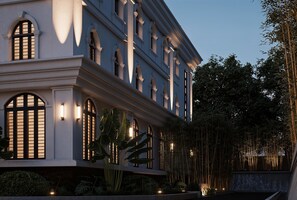 A large, multi-story building with arched windows and a balcony. - Horkeo Boutique Hotel  (Xam Neua)