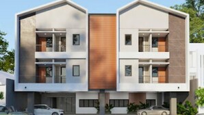 A modern two-story building with a central wooden panel, large windows, and a flat roof. - Lume Stay by Sinergi (Semarang)