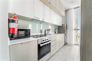 Fridge, microwave, oven, stovetop - Stylish 1BR in Production City with pool and gym (Dubai)