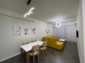 Family Apartment, City View | Living area | TV