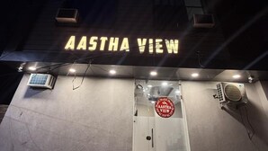 A building with a sign reading "AASTHA VIEW" at the entrance.