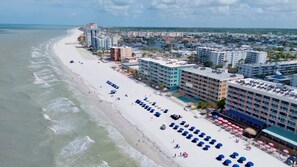 A coastal hotel with a beach view, multiple floors, and a pool area. - Spacious First Floor Gulf Front Condo - RS102 (N. Redington Beach)