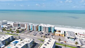 A coastal hotel with multiple buildings, a parking lot, and a beach view. - Ram Sea 204 is a Gold 2-bedroom 2 bath Gulf Front Condo (N Redington Beach)