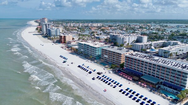 A coastal hotel with multiple floors, a beachside location, and a pool area.