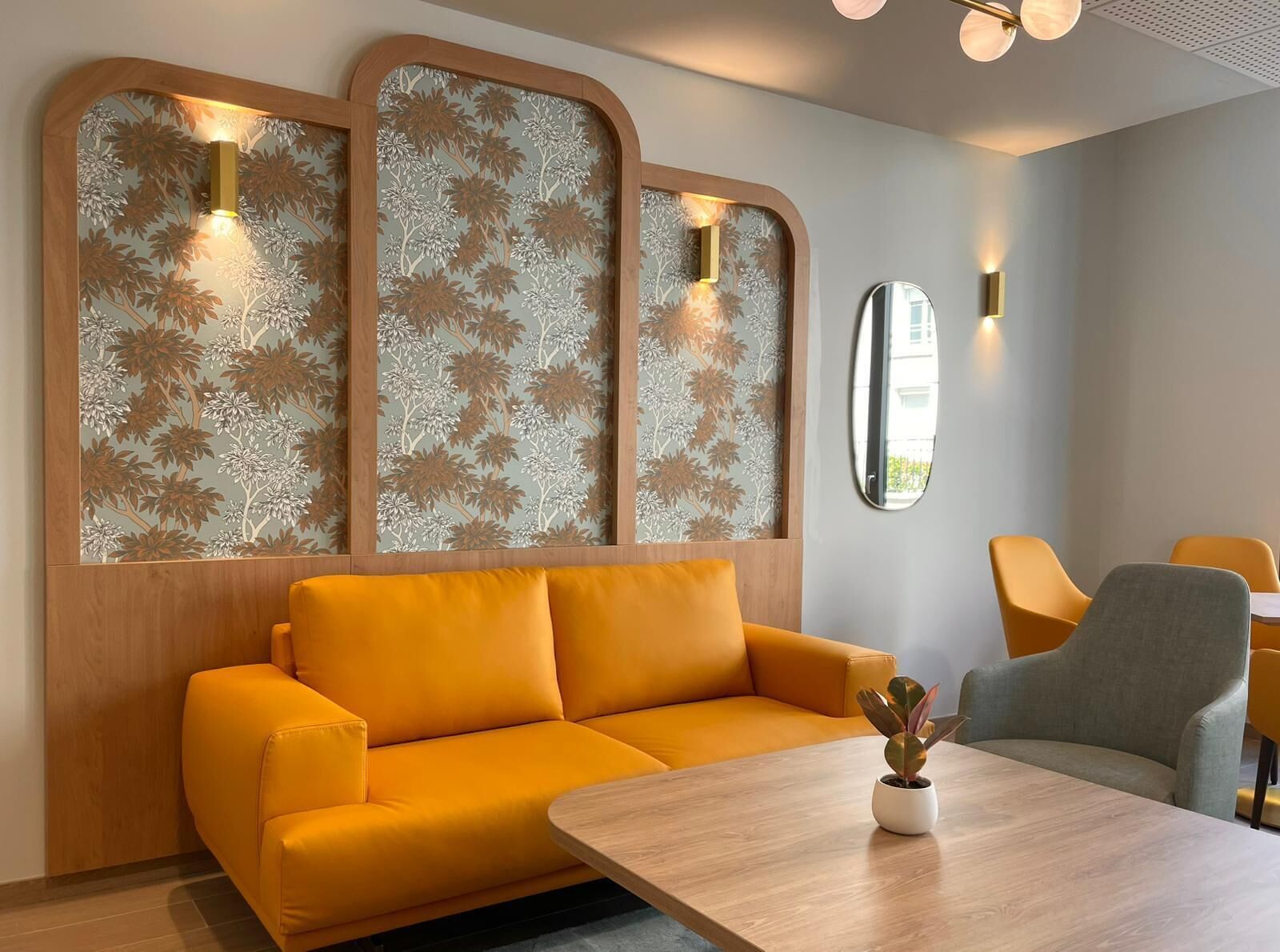 A modern interior with a sofa, a table, and chairs.