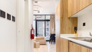 A modern kitchen with wooden cabinets, a white countertop, and a built-in sink.