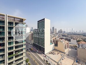 A modern high-rise building with multiple floors, large windows, and a prominent glass facade.