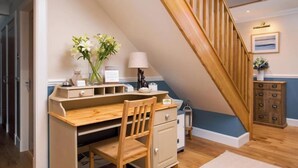A study area with a desk, chair, and a small cabinet. - Blythedale House (Fort William)