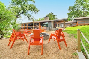 A modern building with outdoor seating and a fire pit. - Waterfront Stonehaven at Reed Point w/ Swim Spa! (Grove)