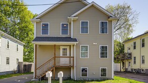 A two-story residential building with a front porch, a staircase, and a small balcony. - 2 Mi to Dtwn Attleboro: Pet-friendly Apt! (Attleboro)