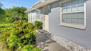 A residential house with a front porch, a door, and a window. - 7 Mi to Beach: Cozy Home w/ Yard in Englewood! (Englewood)