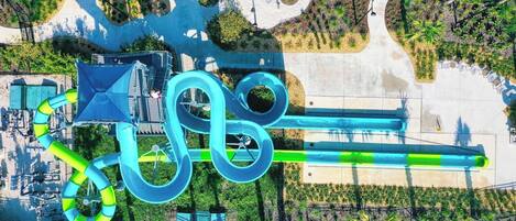 An aerial view of a water park with multiple slides and pools.
