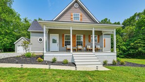 A two-story house with a porch, a small attached garage, and a well-maintained lawn. - Pool, Lake Views, Dock & More: Mt Vernon Getaway (Mount Vernon)