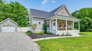 A two-story house with a front porch, a garage, and a well-maintained lawn. - Pool, Lake Views, Dock & More: Mt Vernon Getaway (Mount Vernon)