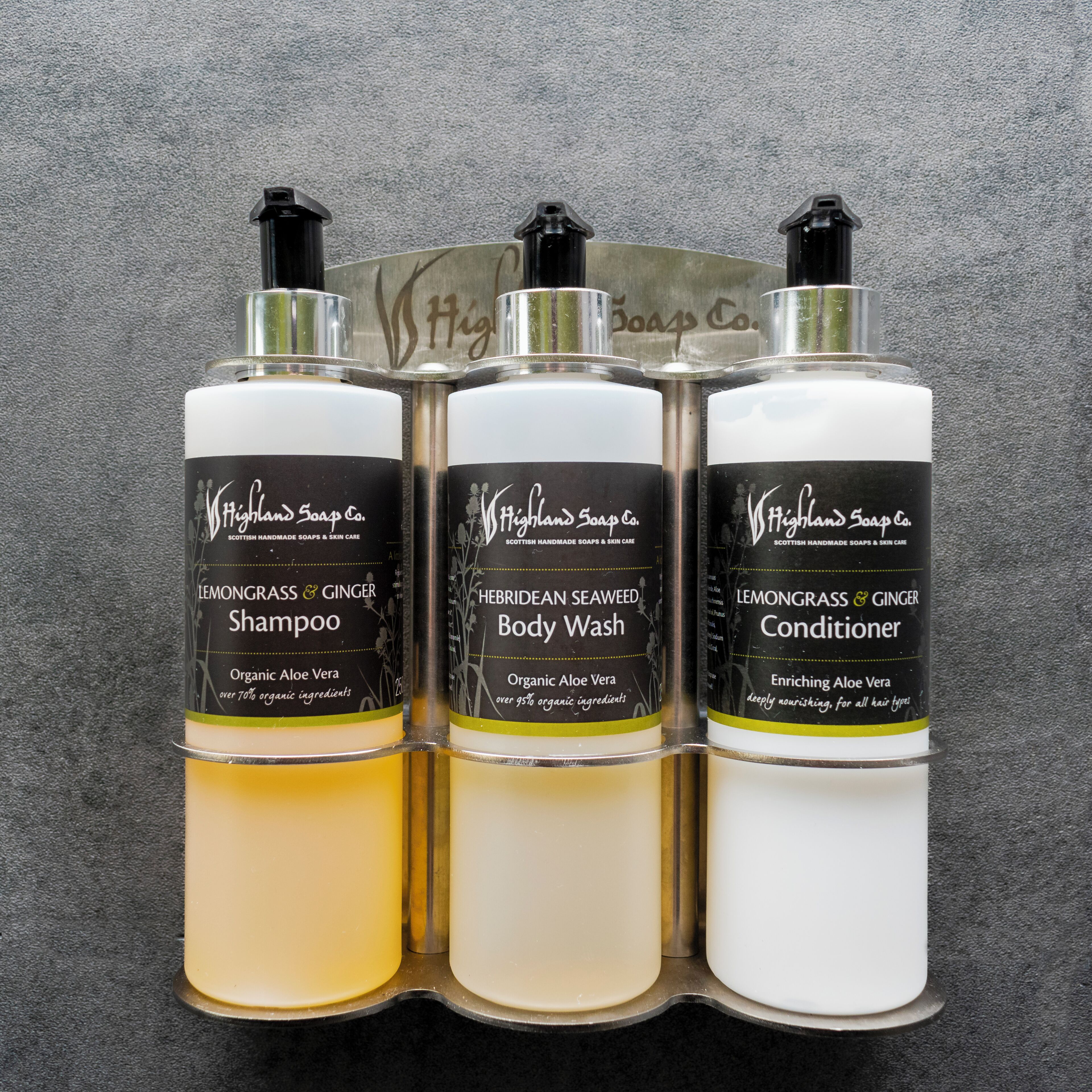 Three bottles of Highland Soap Co. products in a display case.