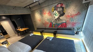 A modern hotel room with two beds, a dining area, and a mural on the wall. - US31 Yamanote Line a famous Japanese designer apartmentdirectly to Ueno2 minutes (荒川区)
