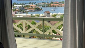 A balcony with a view of a coastal town, including buildings, a hill, and the sea. - Fantastic villa Rodney Bay with epic views! Private pool, fab location 8 guests (Rodney Bay)