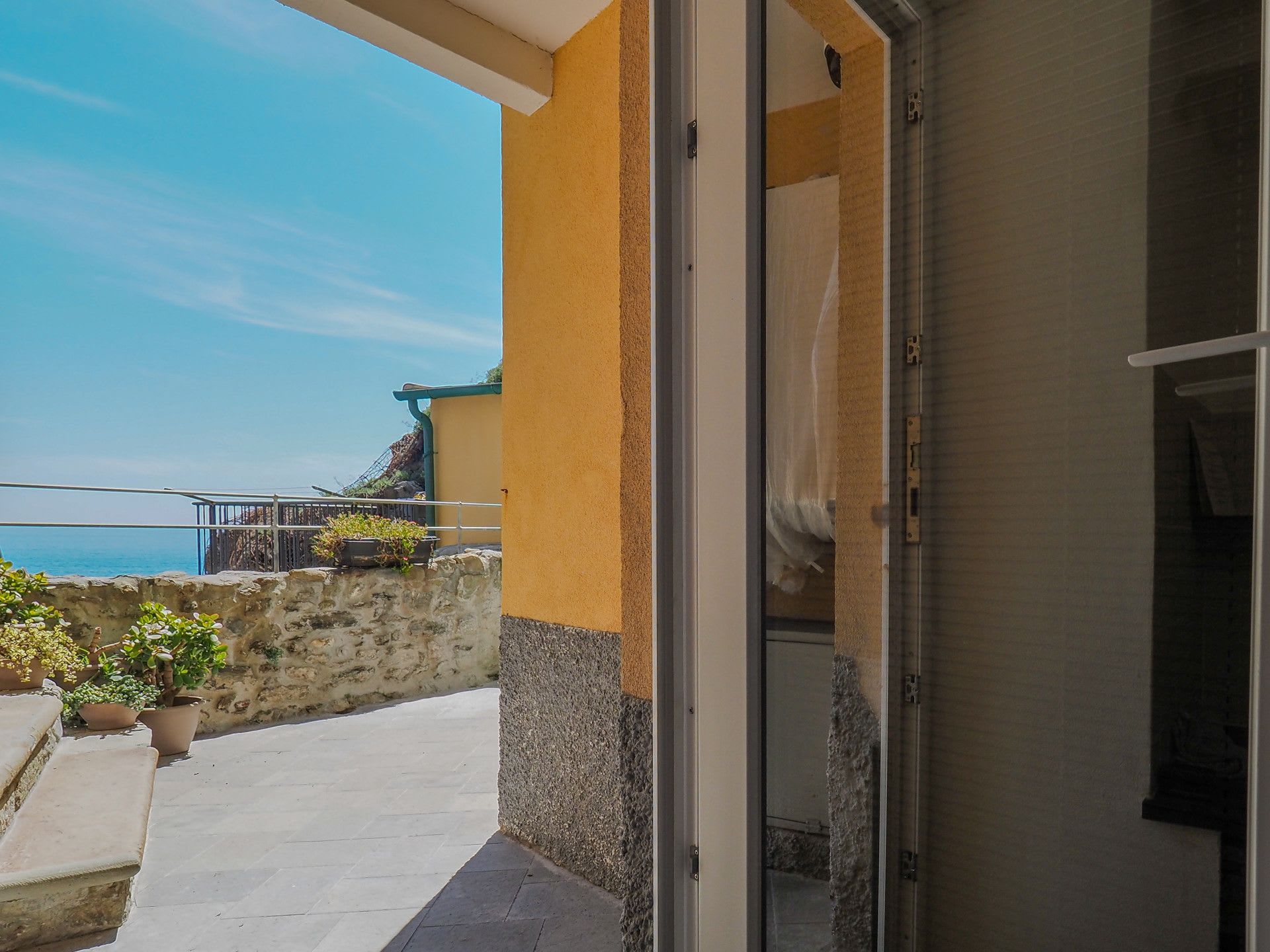 Balcony door onto the village and sea