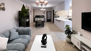 Basic Apartment | Living area | 55-inch Smart TV with satellite channels