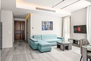 Basic Apartment | Living area | 55-inch TV with satellite channels - The Axis Luxe Loft 1 BDR @ Al Jazi New Cairo (New Cairo)