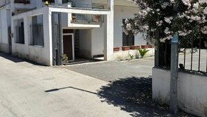 A street view with a building that has a balcony and a gated entrance. - GranComfort between Naples and Caserta (Castel Volturno)