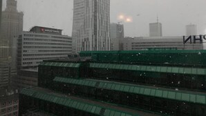 A cityscape with a prominent building labeled "Warsaw Towers" and a green-roofed structure in the foreground. - CityCenter ŚLISKA studio (Warszawa)