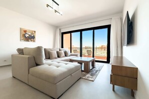 Basic Apartment | Living area | 55-inch Smart TV with satellite channels