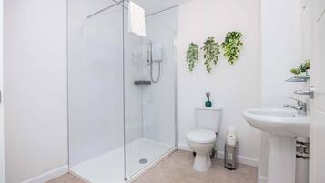 Shower, hair dryer, towels, shampoo