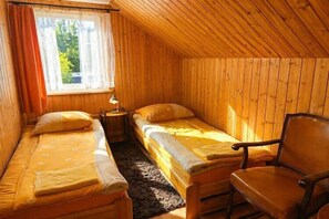 A room with two beds, a chair, and a window. - Holiday apartment for 4 people, Wiselka (Wisełka)