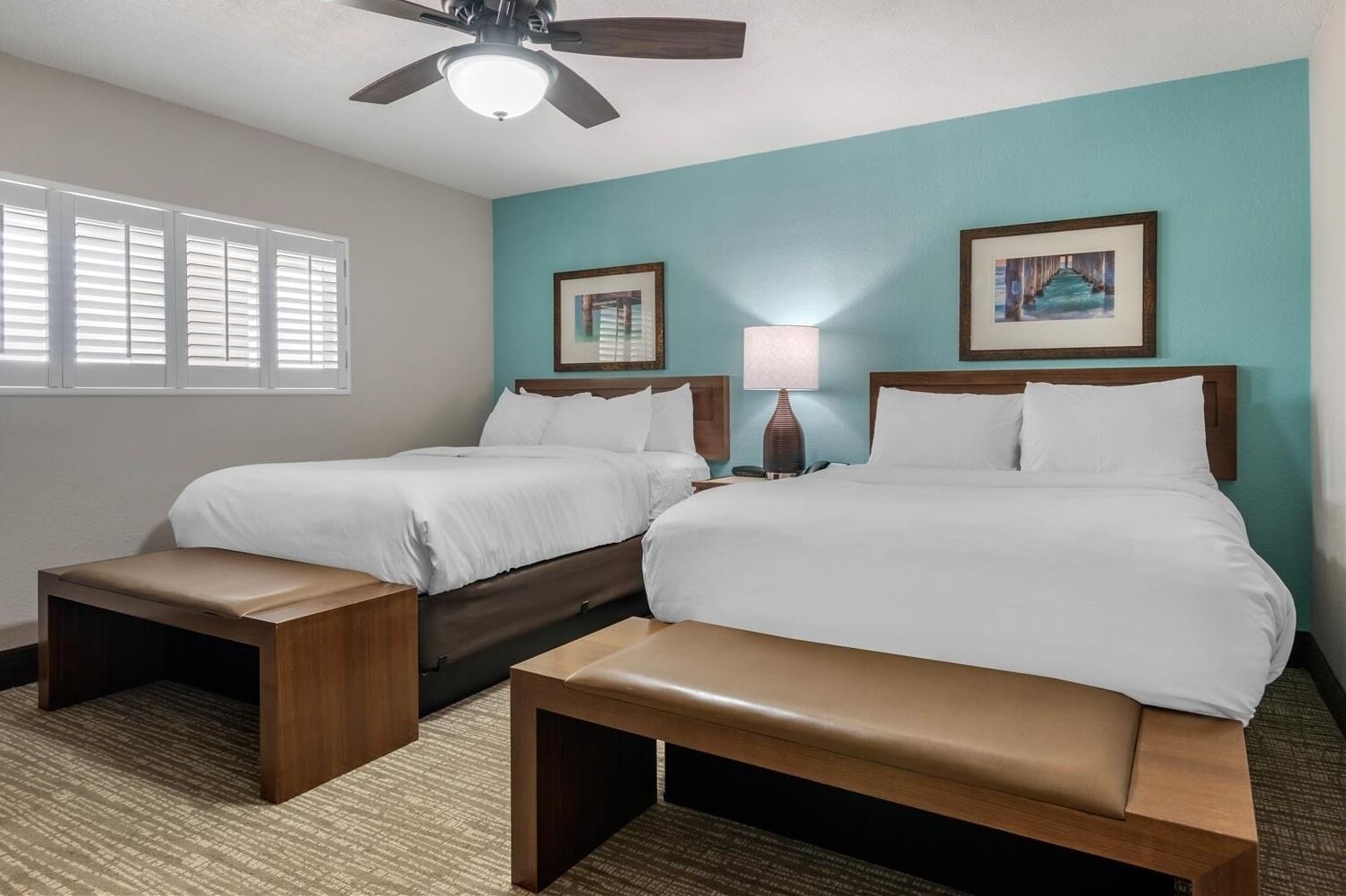 Unwind in crisp linens with soothing coastal accent wall.