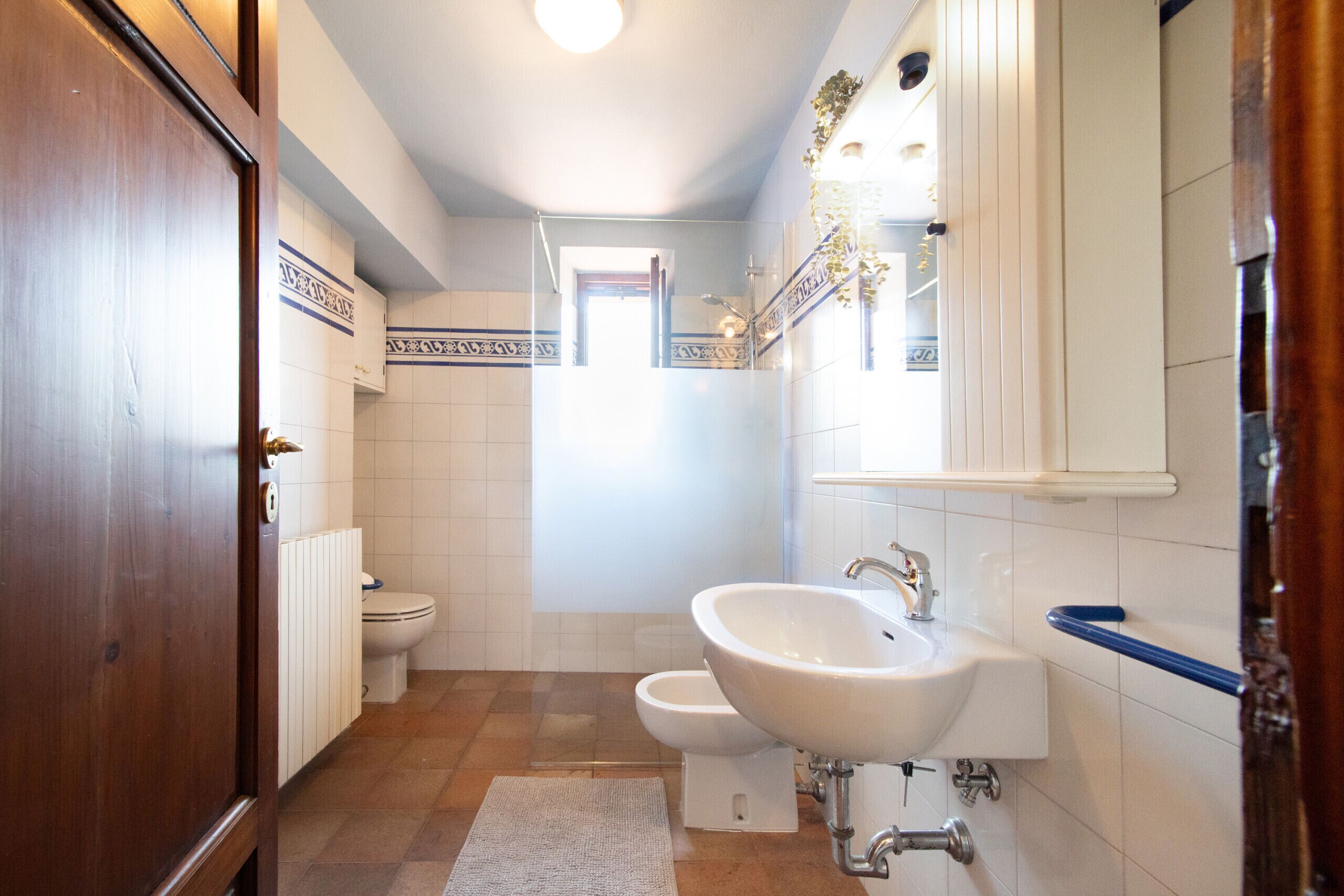 Un baño con lavamanos blanco, inodoro y bidé.