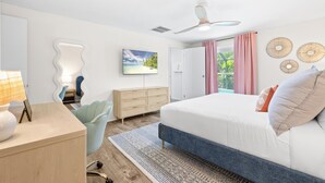 A modern bedroom with a bed, a desk, a chair, a dresser, and a ceiling fan. - Family Resort Near Beaches, with Heated Pool, Hot Tub, Mini Golf & Games (Bradenton)