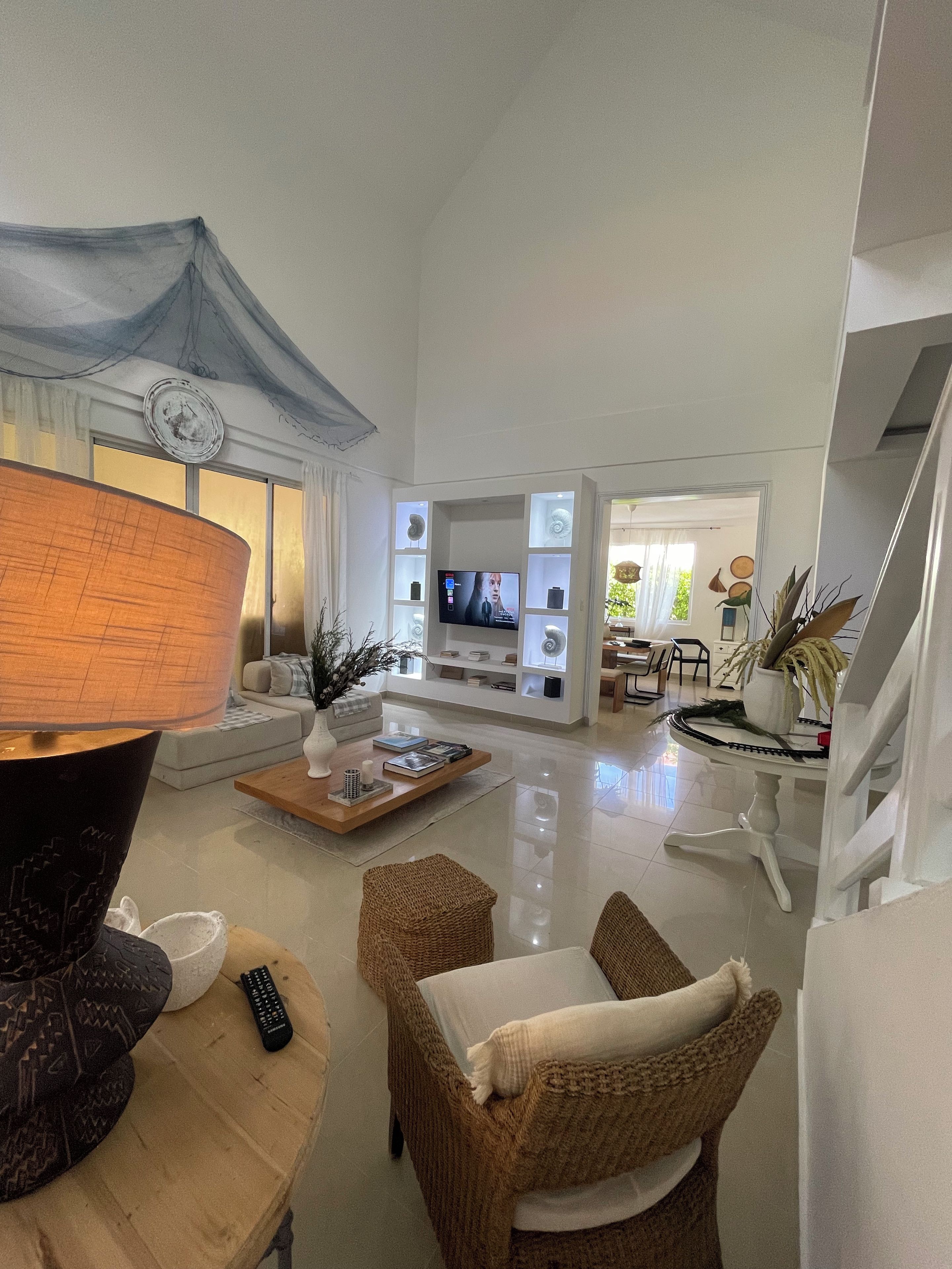 A spacious living room with a television, a coffee table, and a sofa.
