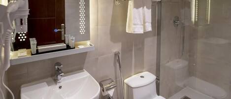 A modern bathroom with a sink, toilet, and glass-enclosed shower.