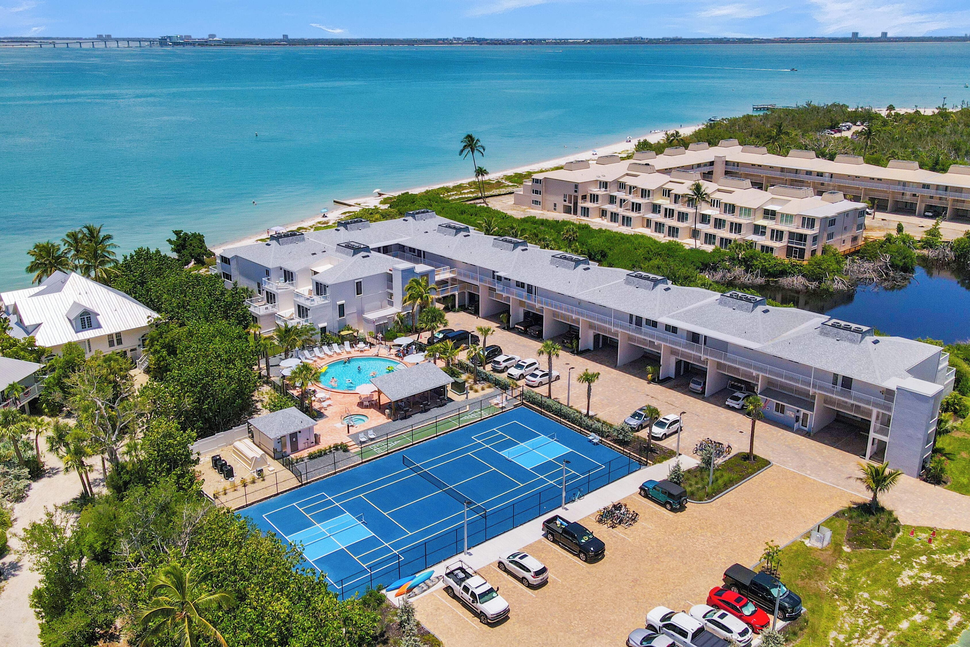 A resort with a pool, beach access, and a view of the ocean.